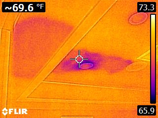 Thermal view of the same ceiling showing a massive leak